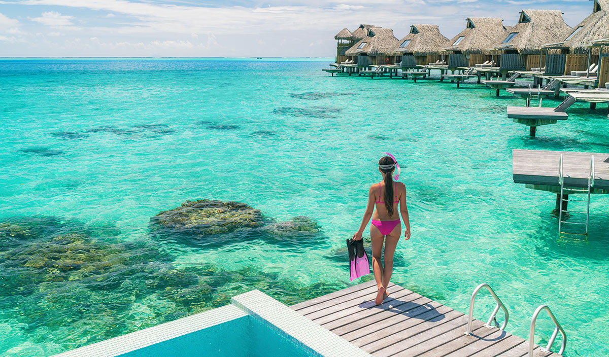 Woman at an overwater bungalow resort