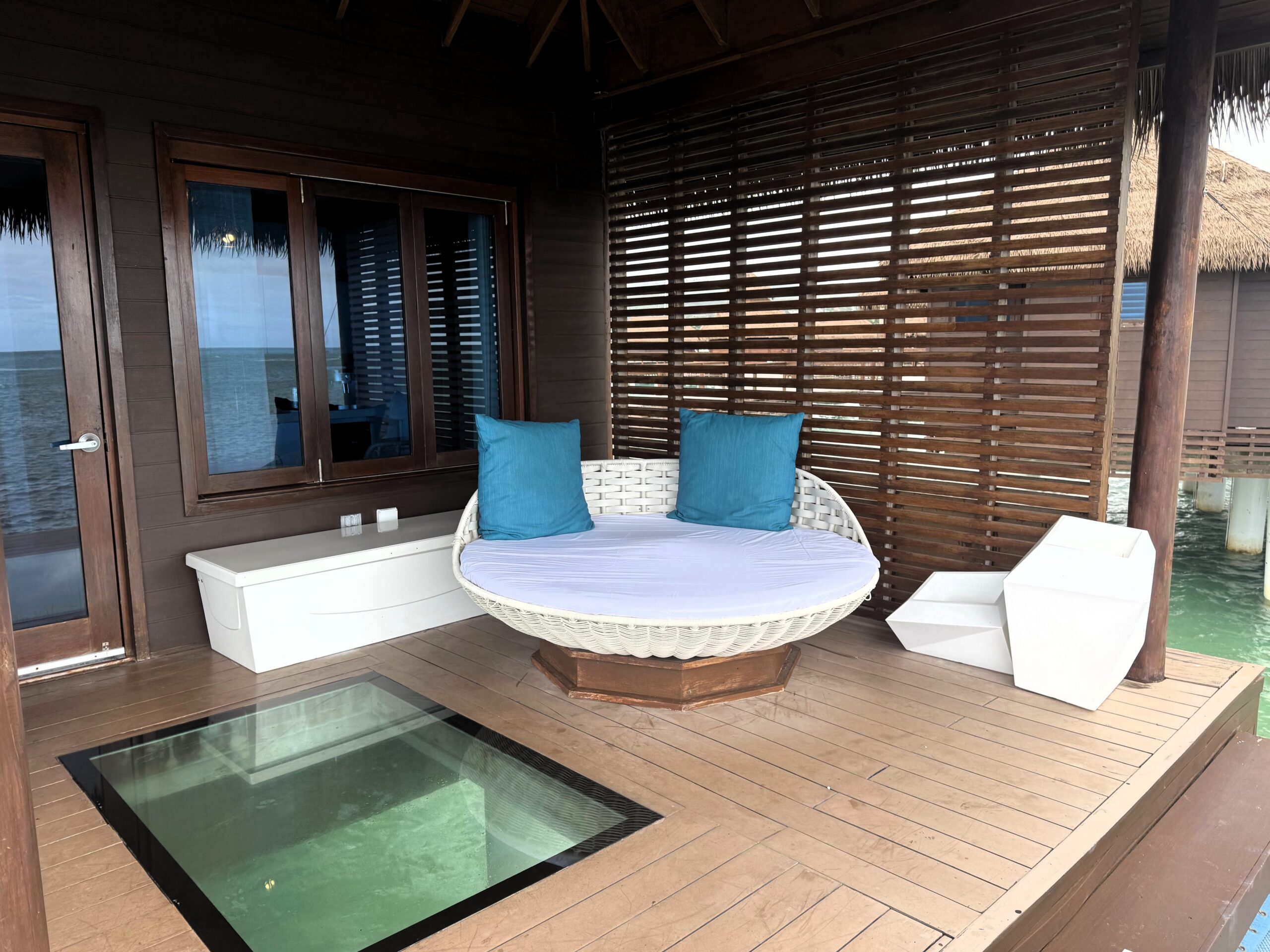 Lower deck daybed and glass floor panel at the Overwater Private Island Butler Villa (OWV) at Sandals Caribbean Cay