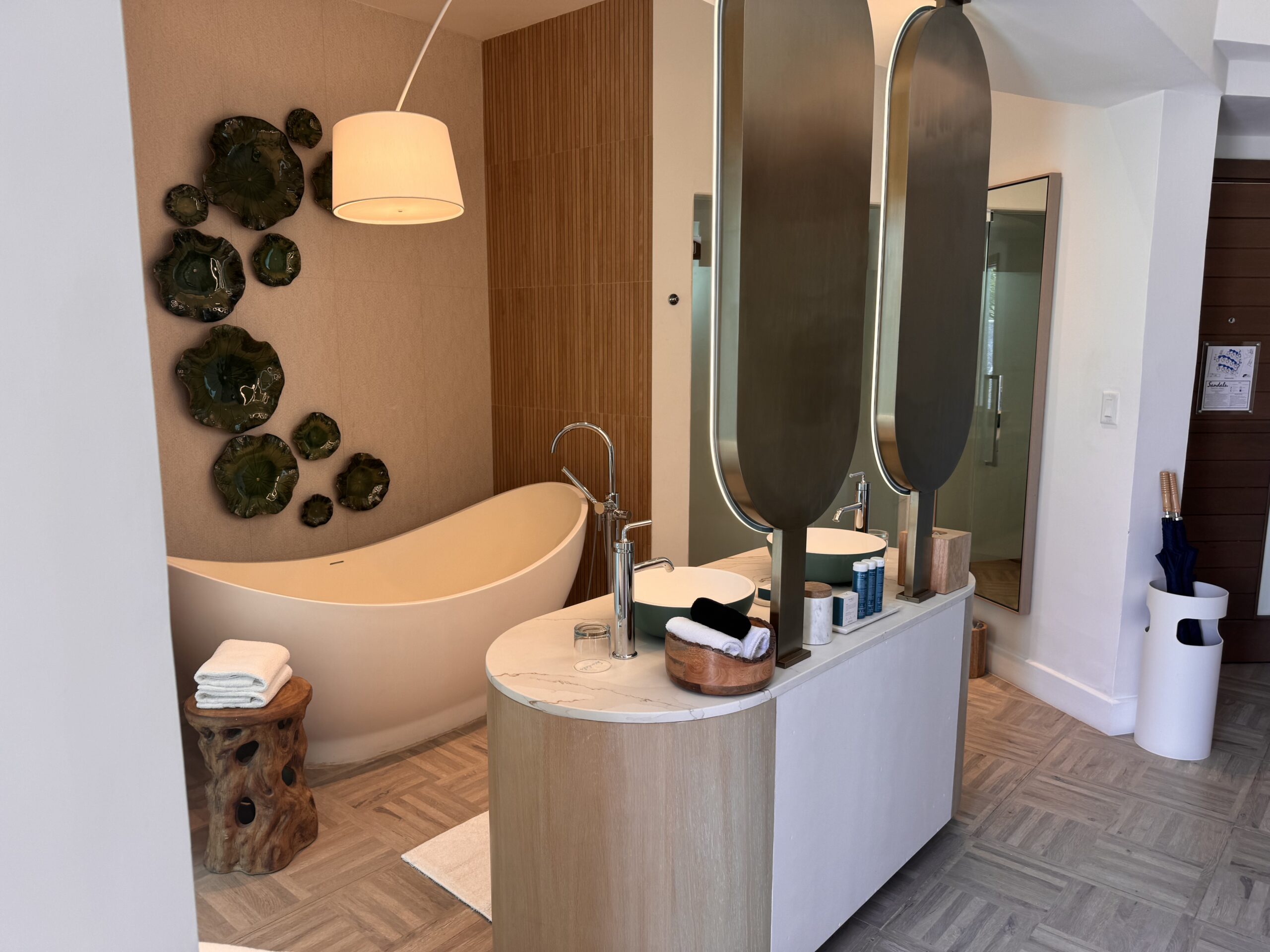 Bathroom in the Coyaba Sky Villa Rondoval Butler Suite (SKYV) at Sandals Dunn's River, with a freestanding soaking tub and double vanity