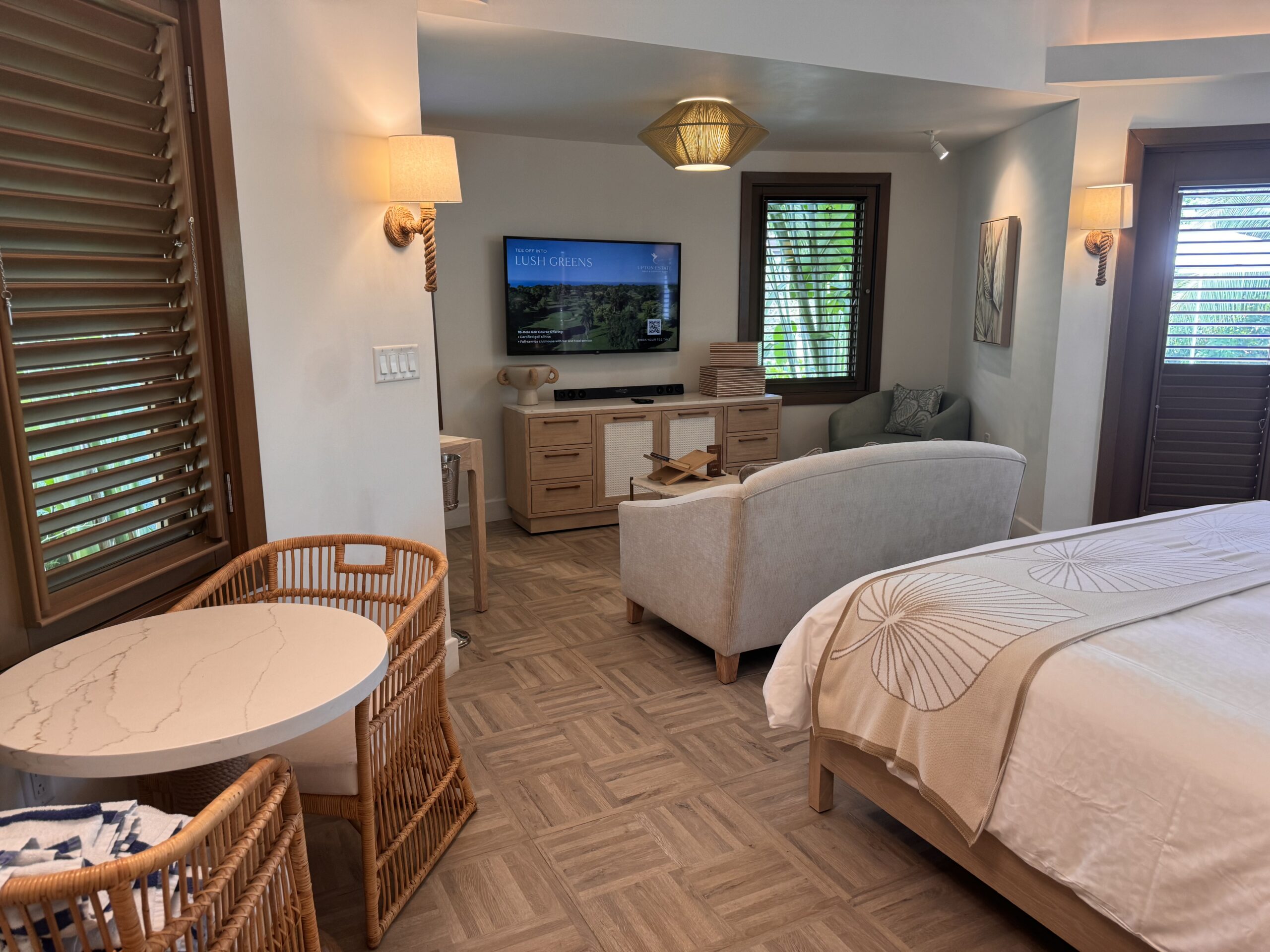 Interior of the Coyaba Sky Villa Rondoval Butler Suite (SKYV) at Sandals Dunn's River, with a king bed, sofa, and living area