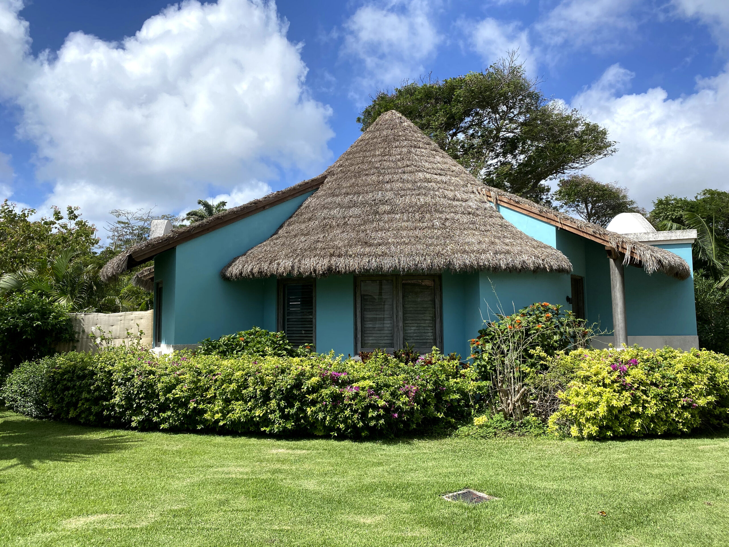 Exterior of the South Seas Royal Rondoval Butler Suite (RPP) at Sandals Royal Barbados, a stand-alone thatched-roof round villa in a tropical garden