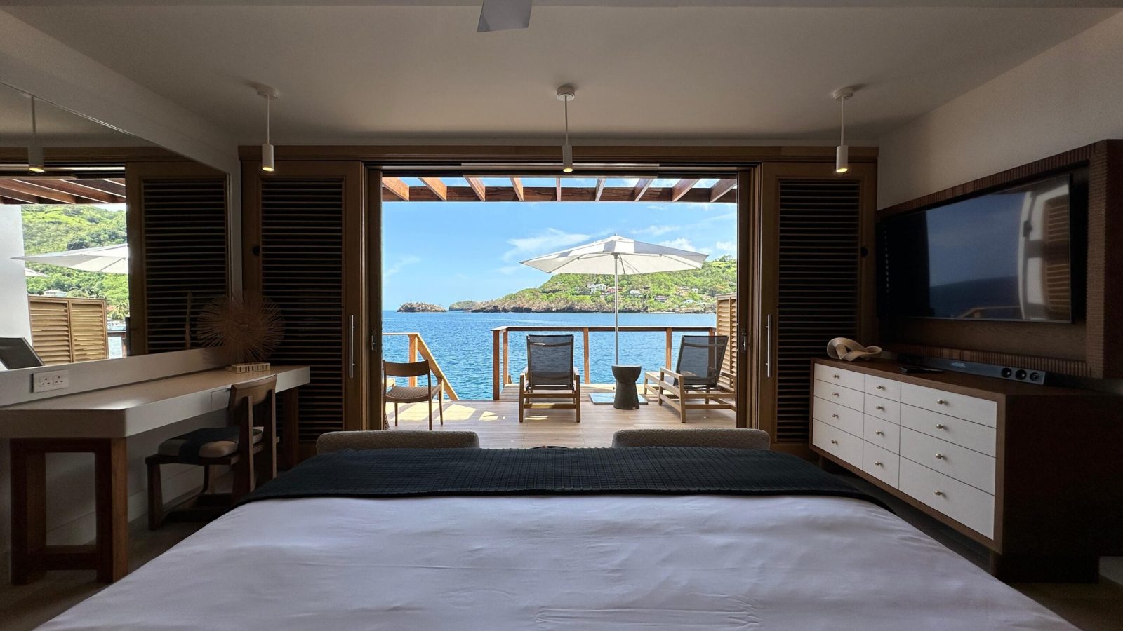 Vincy Overwater Two Story Villa (OWV) bedroom view of ocean and private deck at Sandals Saint Vincent
