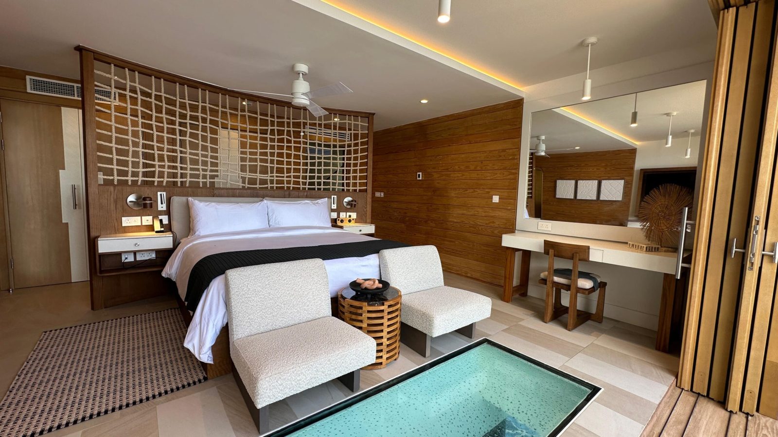 Vincy Overwater Two Story Villa (OWV) bedroom at Sandals Saint Vincent with glass floor