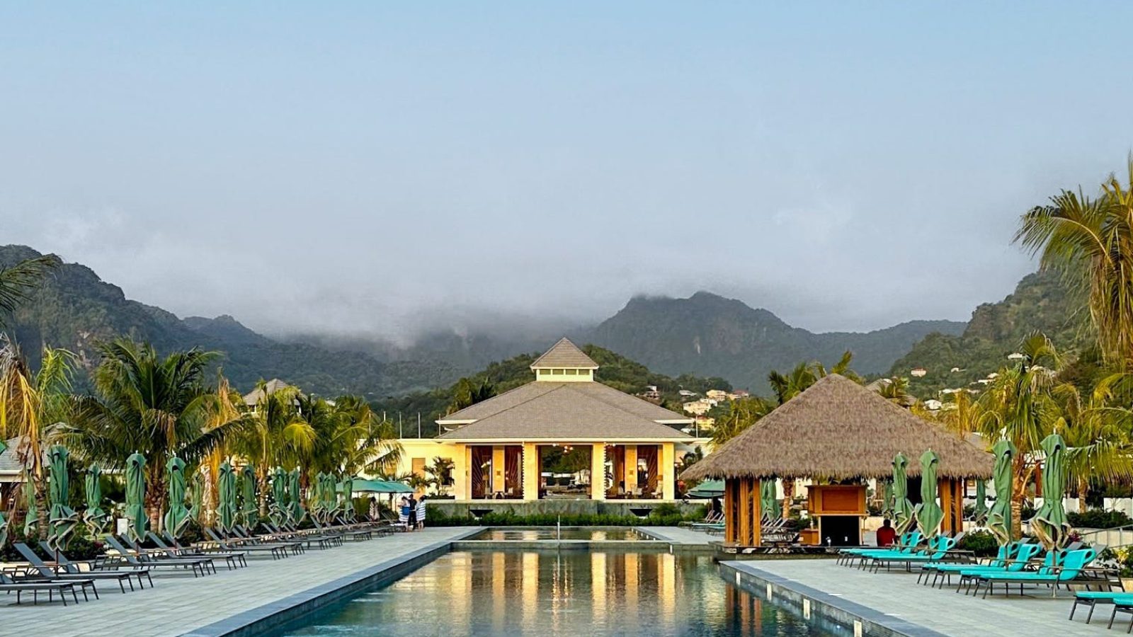 Main pool at Sandals Saint Vincent with mountains and morning fog, near the Vincy Overwater Two Story Villa (OWV)