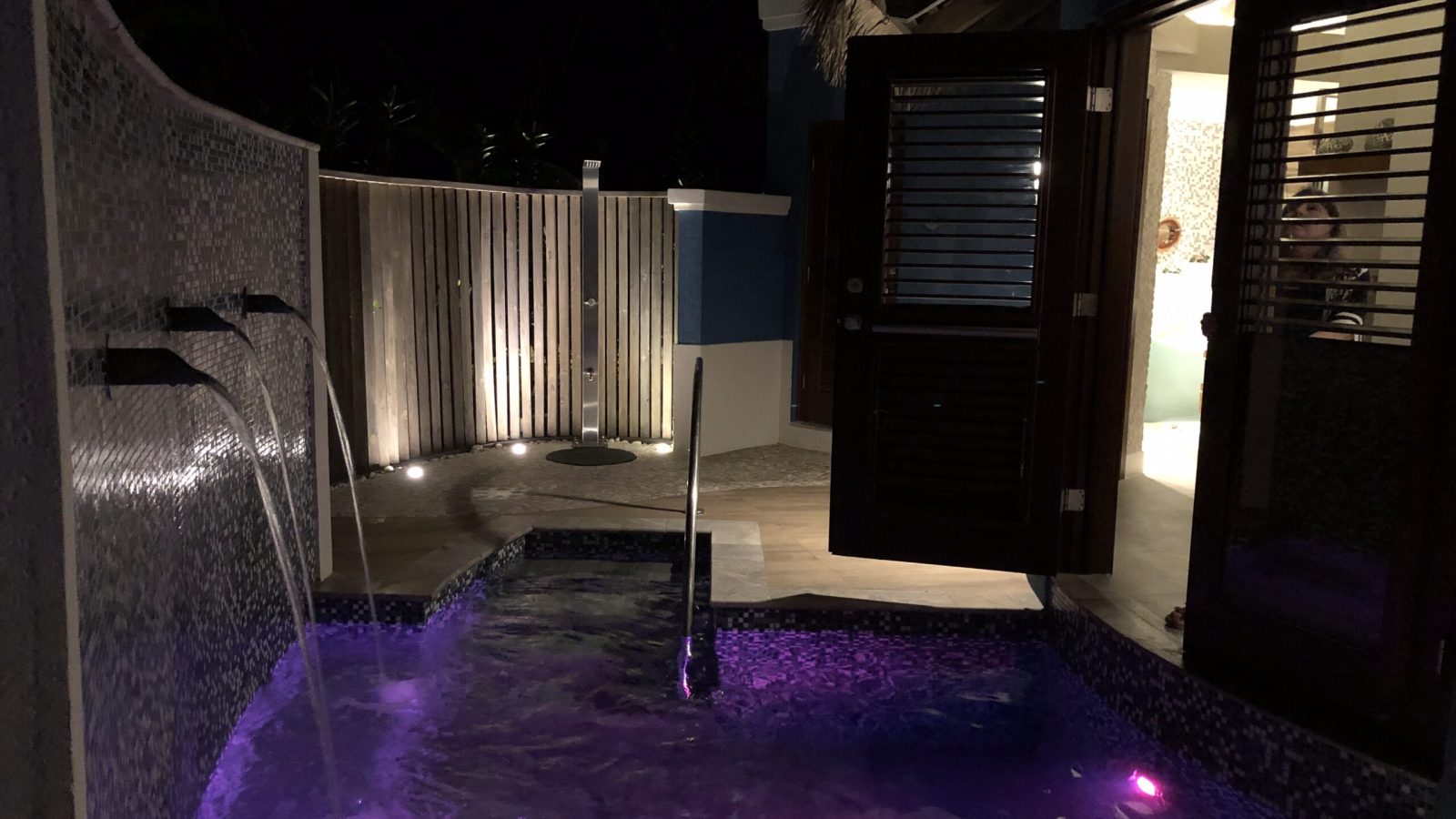 Sandals South Coast Rondoval Swim-Up Butler Villa private plunge pool at night with waterfall and mood lighting