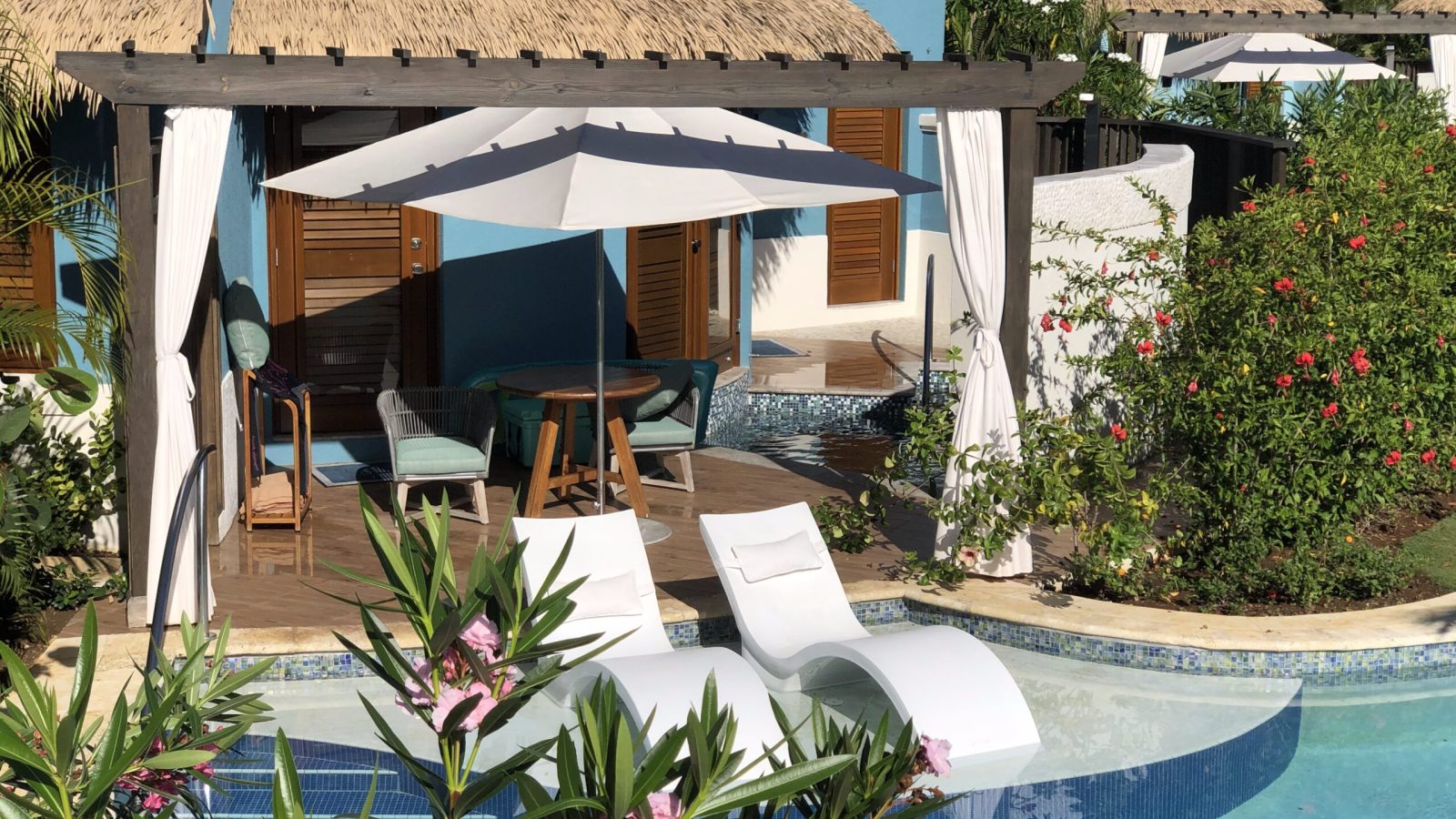Sandals South Coast Rondoval Swim-Up Butler Villa patio with lounge chairs in river pool, deck, and private plunge pool