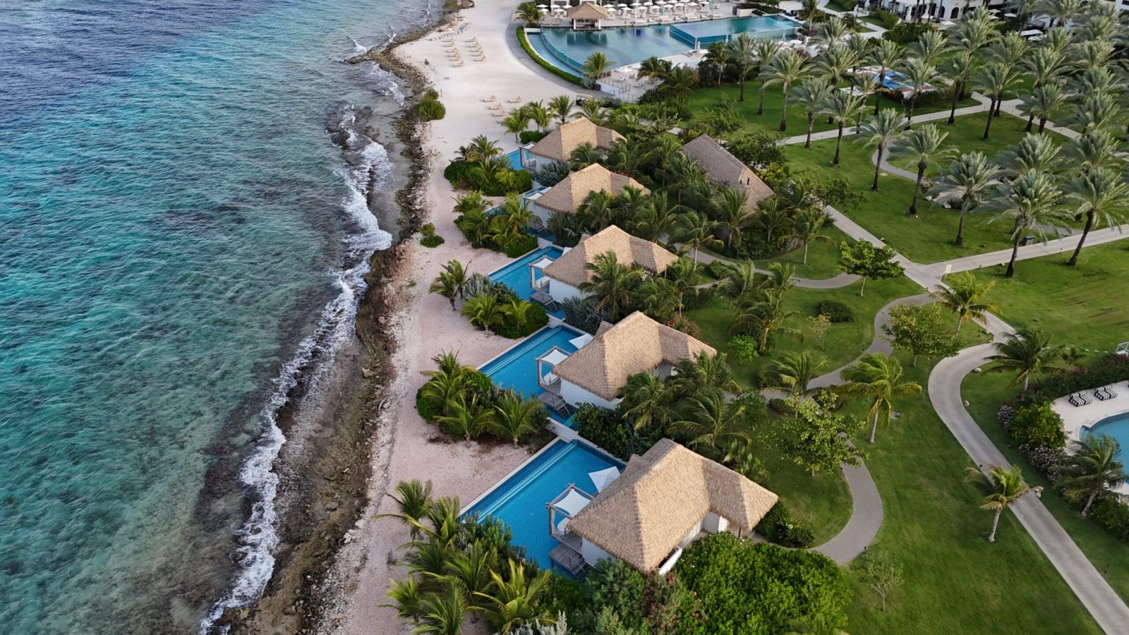 Aerial view of Sandals Royal Curaçao Awa Seaside Bungalows along the ocean