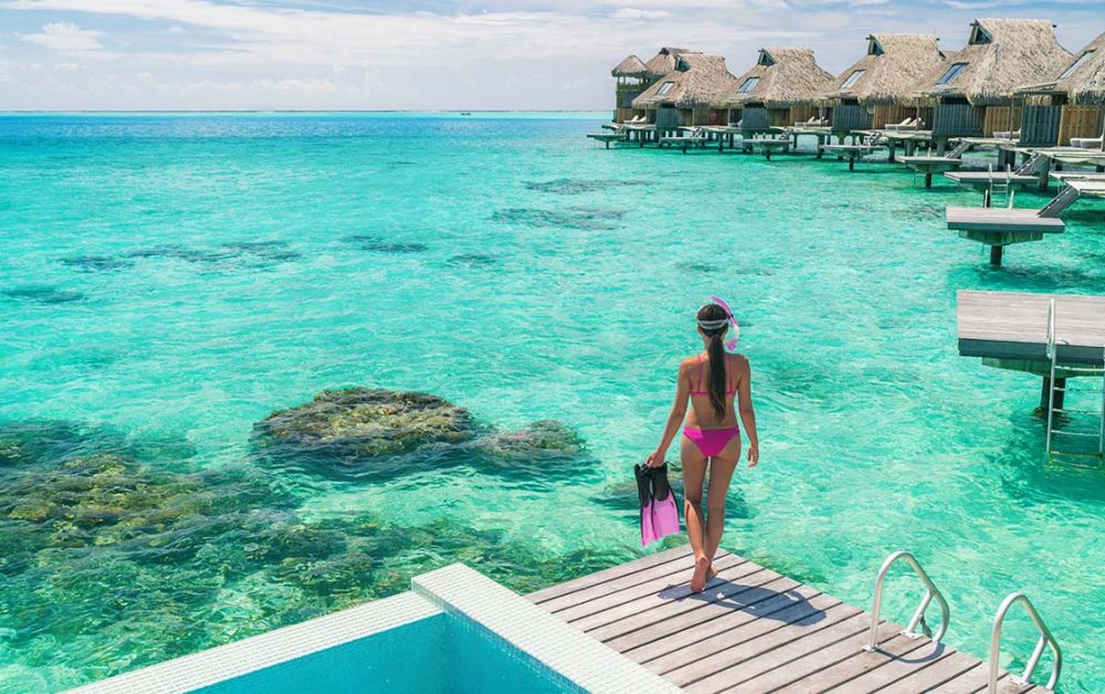 Woman at an overwater bungalow resort