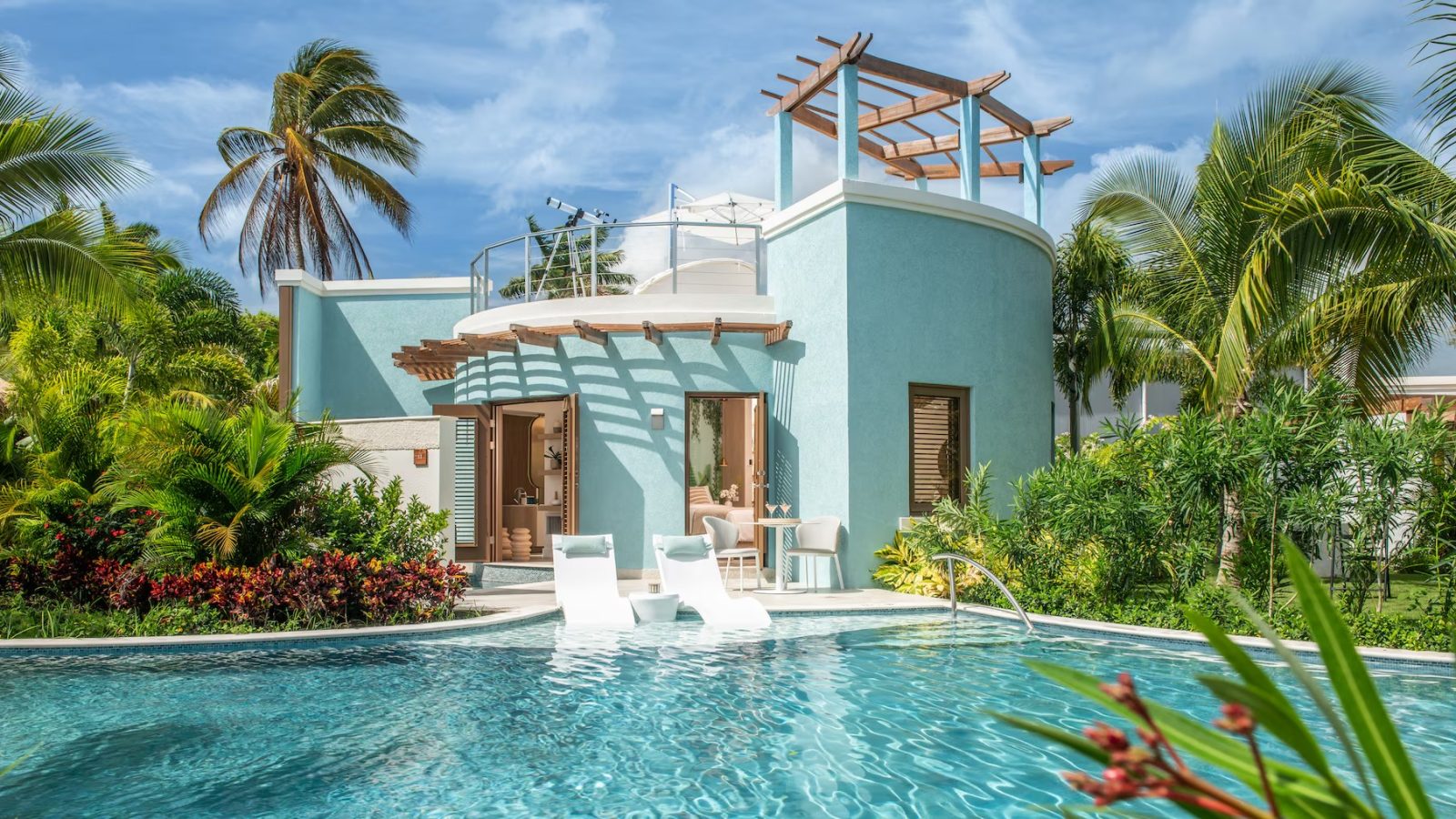 Exterior of the Coyaba Sky Villa Swim-up Rondoval Butler Suite (SKYV) at Sandals Dunn's River, a round villa with a rooftop deck and private swim-up pool