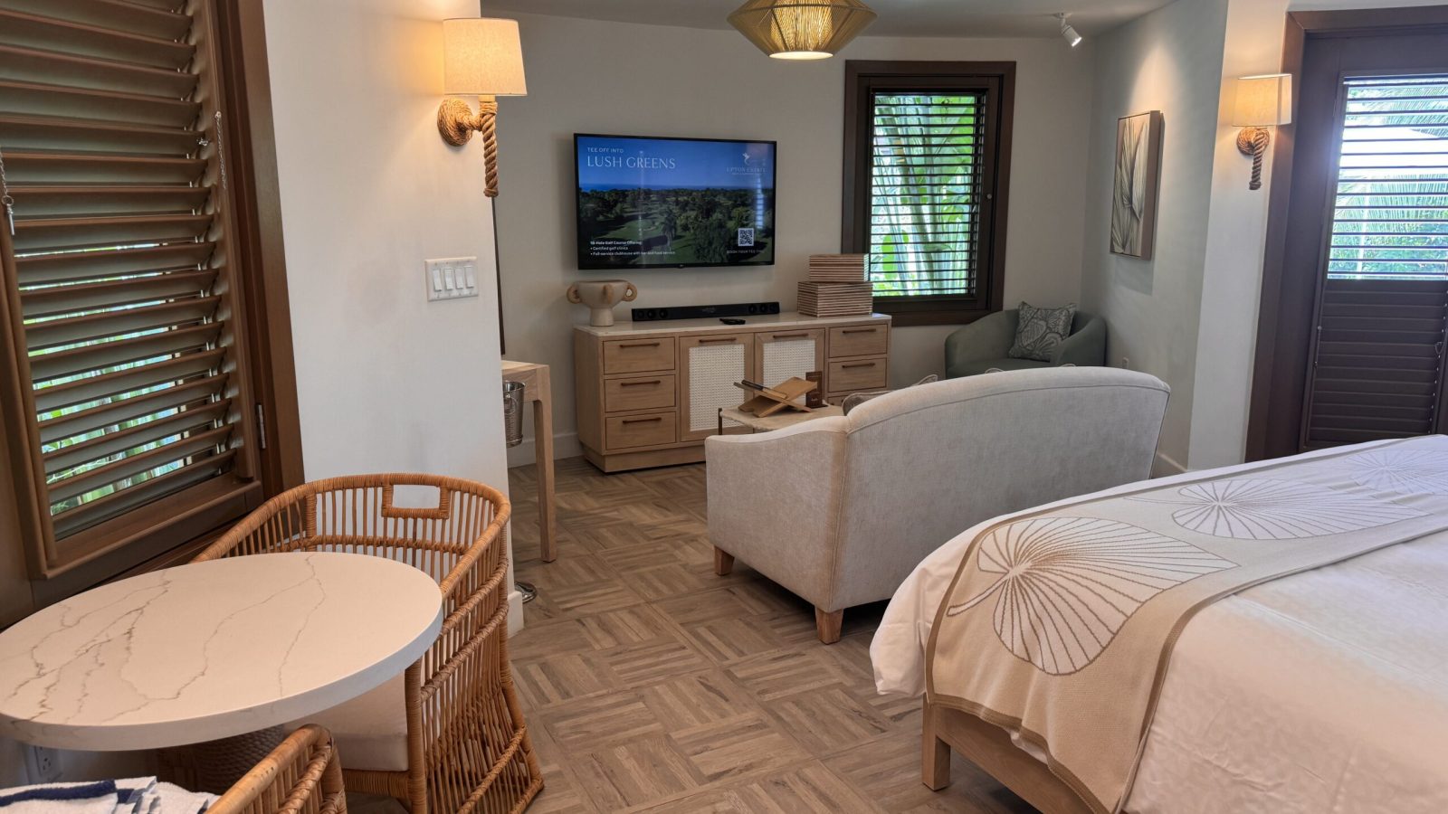 Interior of the Coyaba Sky Villa Rondoval Butler Suite (SKYV) at Sandals Dunn's River, with a king bed, sofa, and living area