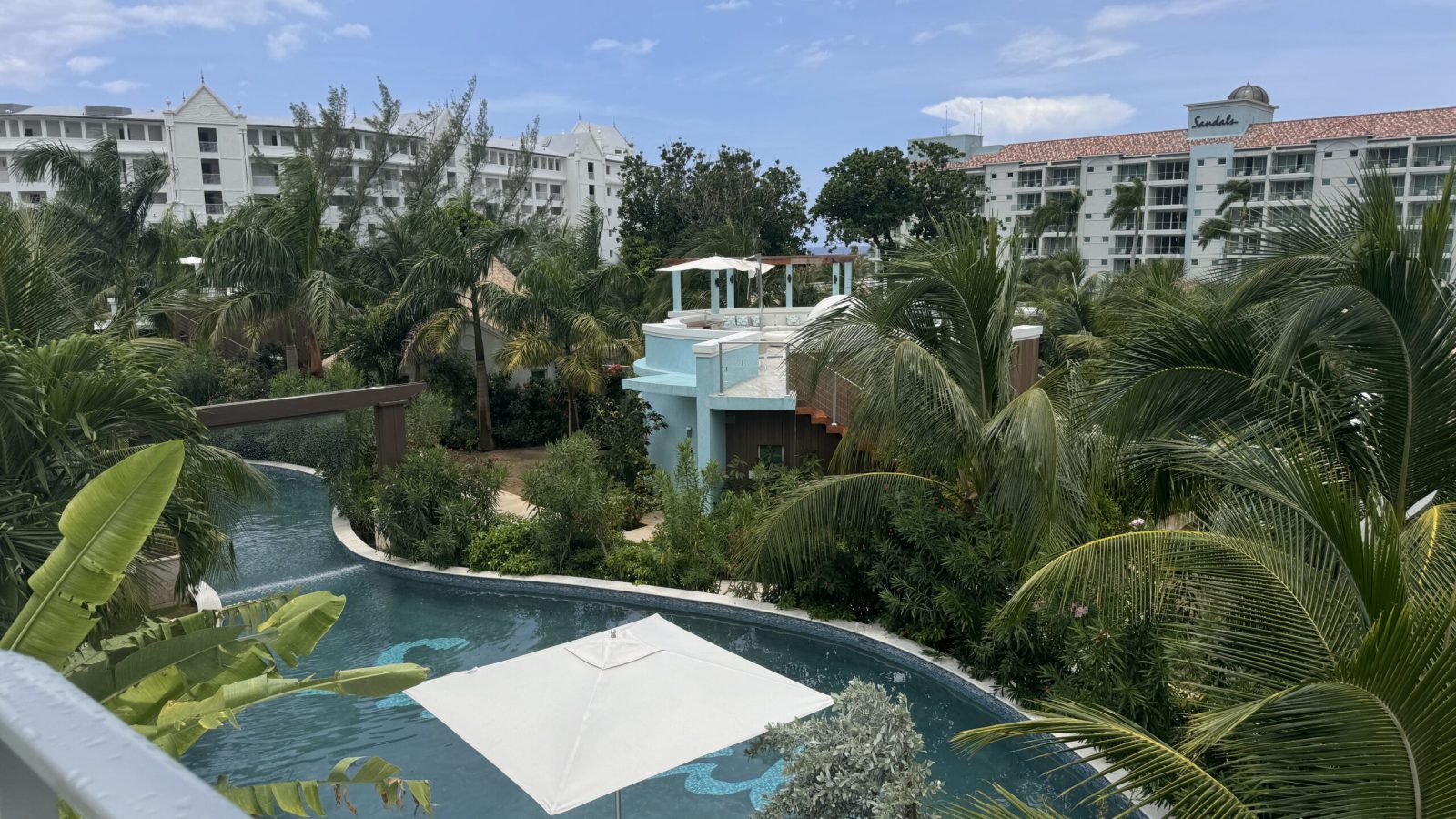 View over the winding pool and gardens from the Coyaba Sky Villa Rondoval Butler Suite (SKYV) at Sandals Dunn's River