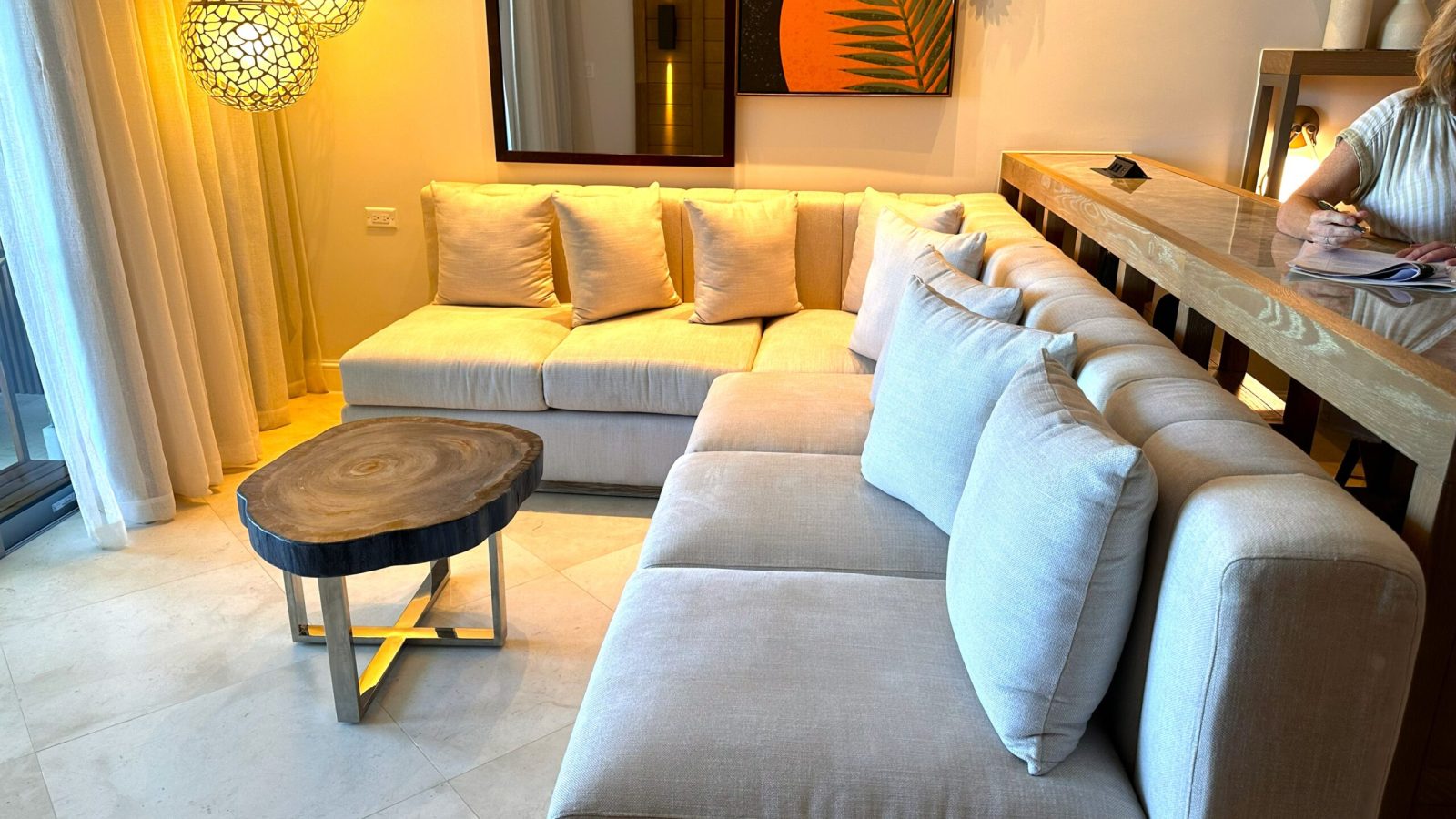 Sandals Dunn's River Tufa Terrace Swim-Up Butler Suite living area with large L-shaped couch between bedroom and patio