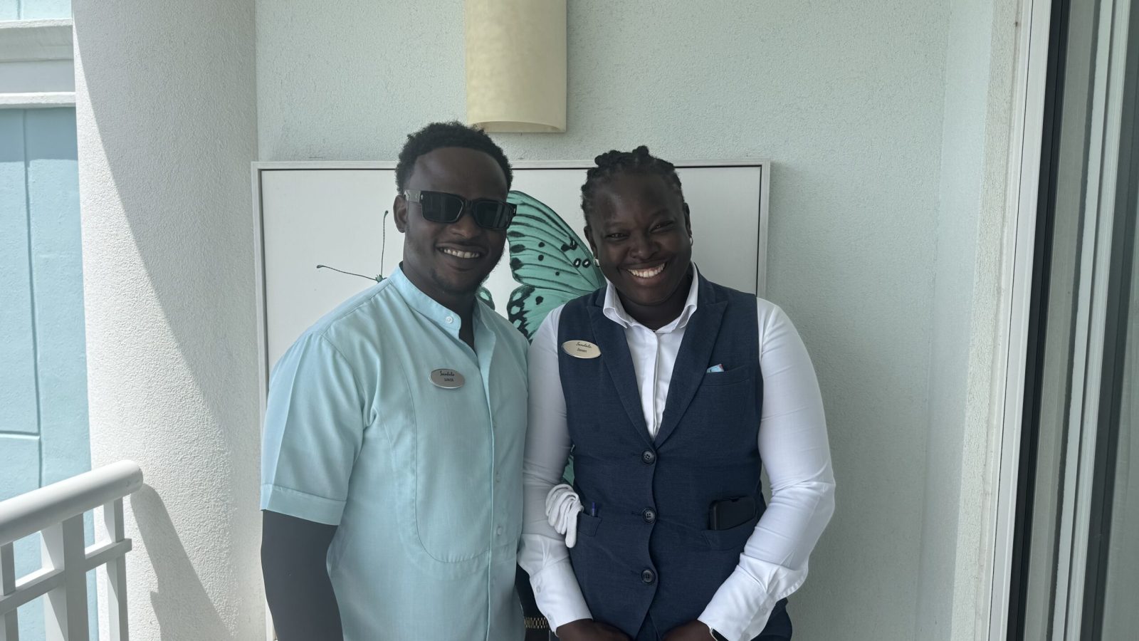 Two Sandals Royal Bahamian butlers outside a guest suite