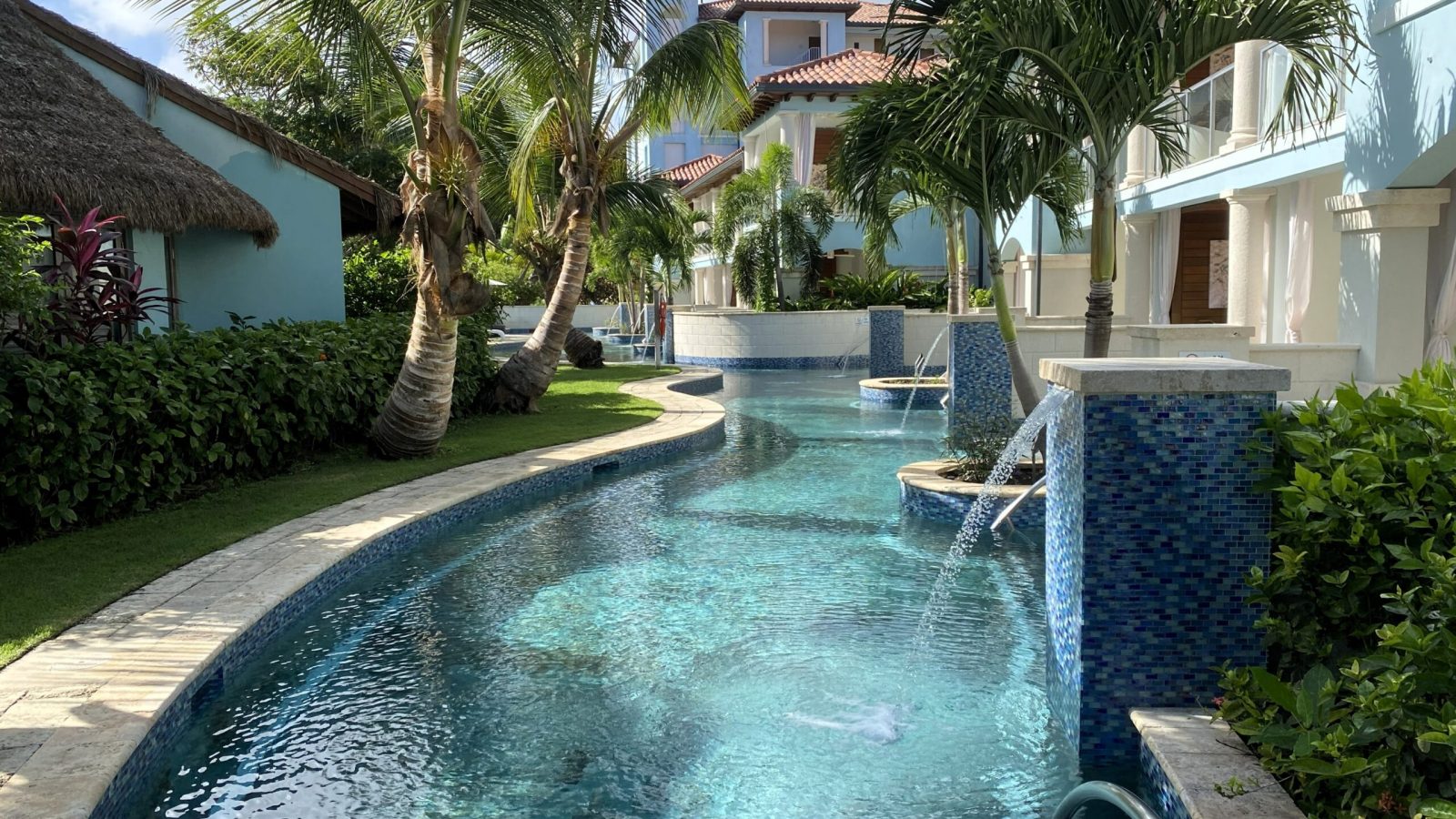 Crystal Lagoon swim-up pool winding between guest room buildings at Sandals Royal Barbados