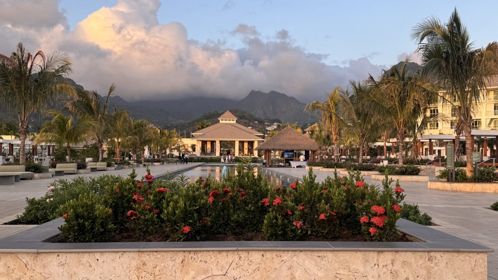 Sandals Saint Vincent resort plaza and reflecting pool at sunset, with the mountains behind